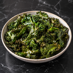 Oven-baked kale leaves cooked until crisp, designed as a quick, low-effort snack or side.
