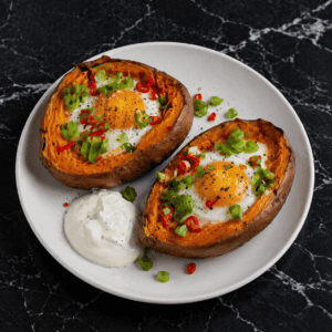 Baked sweet potatoes filled with eggs, finished with chilli and spring onion for a simple oven‑cooked dish.